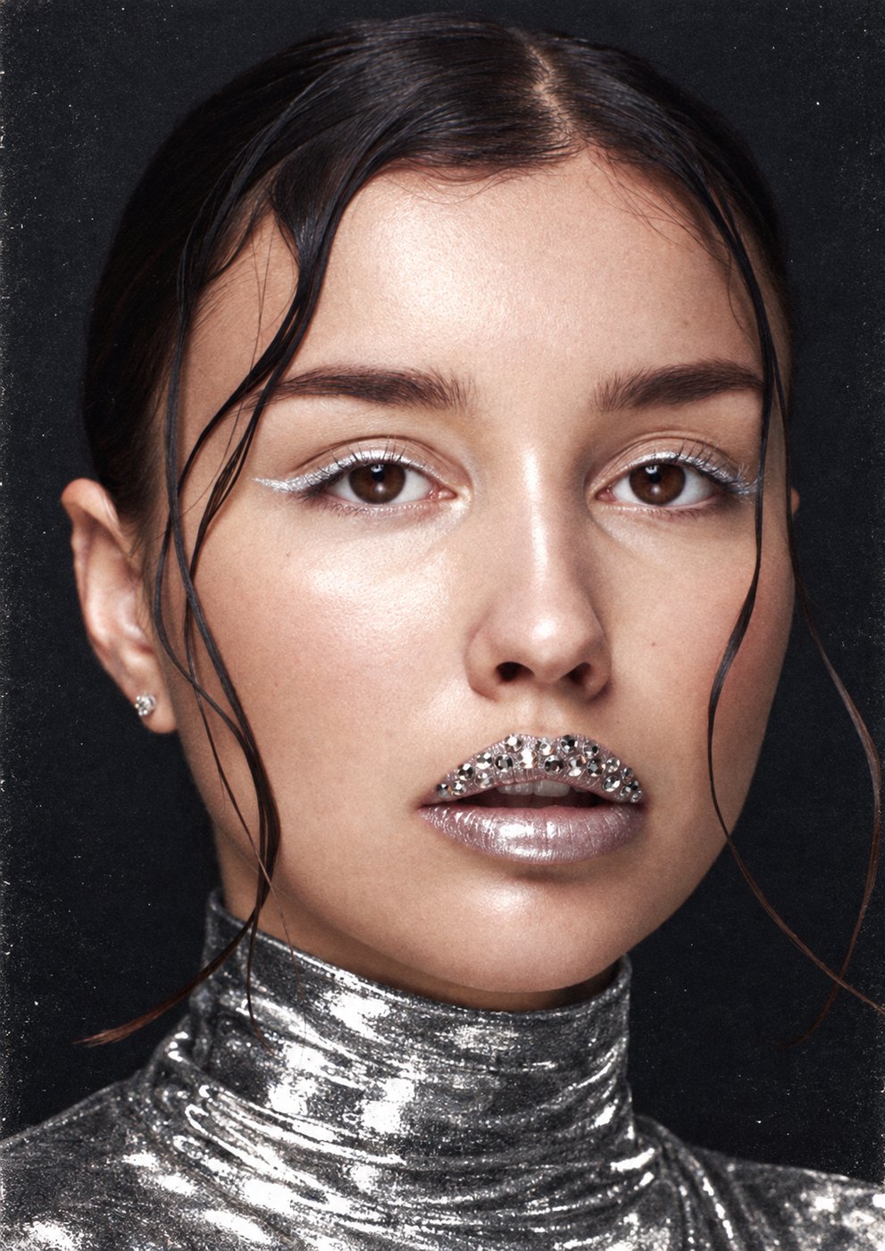 Portrait of Karina with silver eyeliner, crystal-studded lips and a metallic turtleneck