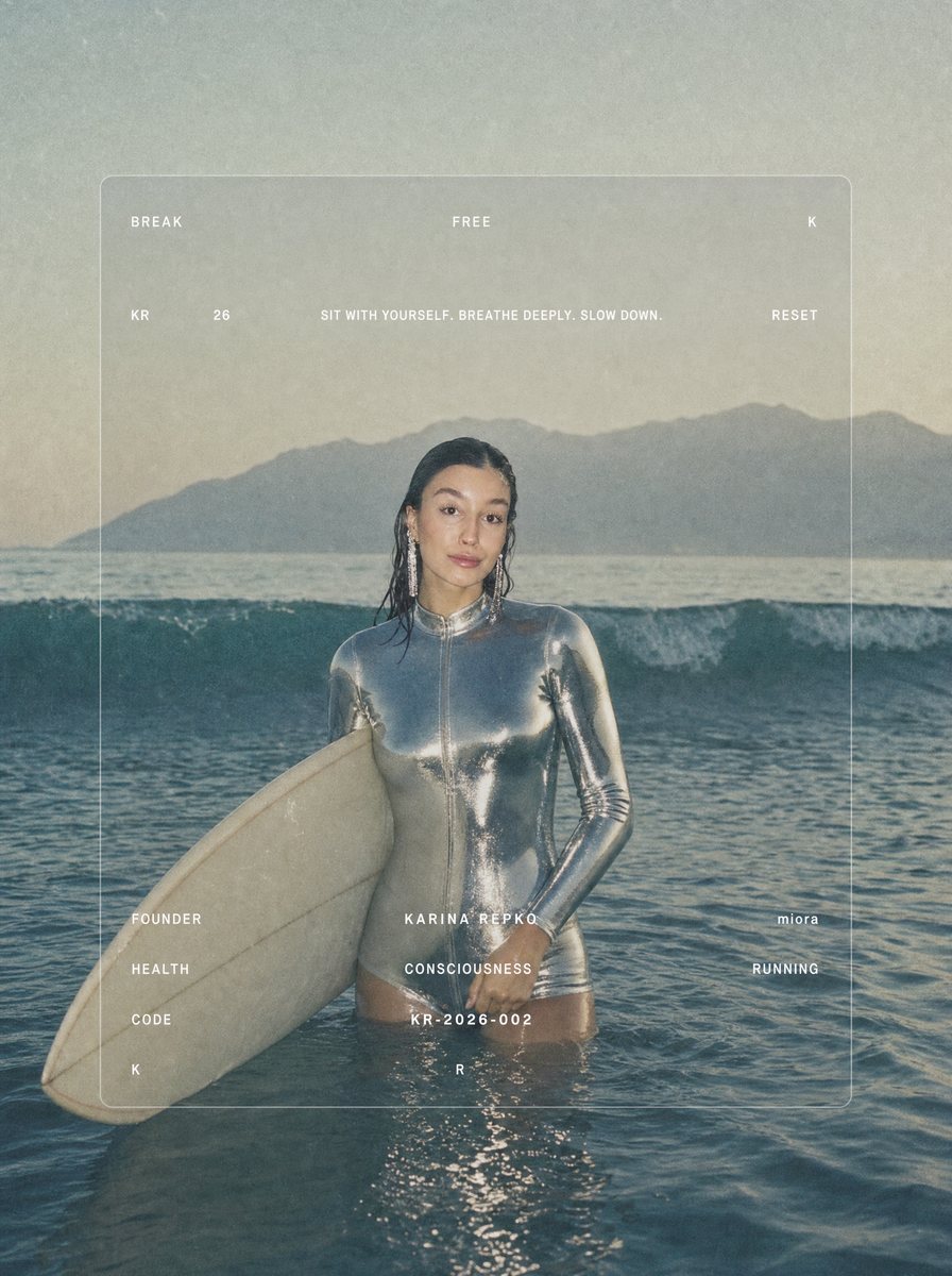 Karina with a surfboard in the ocean